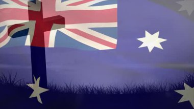Rüzgar, Avustralya bayrağını dalgalandırıyor. Çimen silueti üzerinde sendika bayrağı ve güney çapraz yıldızları sallıyor. Yurtsever, ulusal sembol, kumaş hareketi, açık hava sahnesi, dinamik, jest, vatansever görünüm