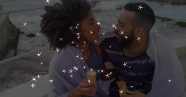 Kadın bankta dondurmadan bir ısırık aldıktan sonra bir çift reklamında öpüşmek için eğildi. Romantik, samimiyet, yaz, sahil, sevgi dolu, samimi, açık hava