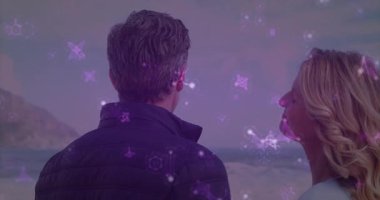 Pazarlama sahnesi, mor yıldızlı çift okyanus kenarında sürükleniyor ve samimi bir eğilim yaratıyor. Romantizm, sükunet, sükunet, alacakaranlık, siluet, bağlantı, rüya gibi