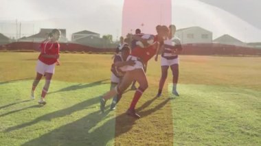 Genç rugby topu taşıyıcısı kırmızı koşu, defans oyuncuları hücum, takım arkadaşları mal bulundurmaya itiraz ediyor. Atletizm, takım çalışması, rekabet, hareket, spor giyim, açık hava, kararlılık