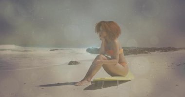 Güneş parlaklığı yaratır, dişi sörfçü çenesini dinlendirir seyahat reklamları için el ufkuna bakar. Plaj, dinginlik, yansıma, eğlence, sahil, açık hava, canlı