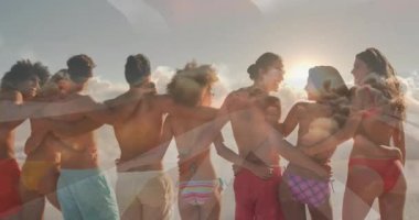 Silah taşıma plajını birbirine bağlayan altı arkadaş, günbatımını kutlarken Union Jack 'in sönen kıvılcımları. Yoldaşlar, eğlence, coşku, uyum, sükunet, bağlantı, açık hava