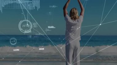 Şebeke grafikleri büyüdükçe adam plajda sağlık için dua etmeye başlıyor. Farkındalık, meditasyon, teknoloji, bağlantı, dinginlik, refah, fütüristik