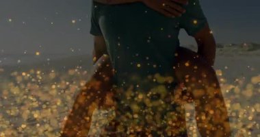 Couple piggybacking along sandy shoreline in travel, causing floating golden sparkles. Romance, adventure, leisure, outdoor, joy, intimacy, carefree