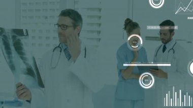 Dr examining X-ray while nurse pointing tablet and revealing charts in medical clinic to diagnose. Medical, collaboration, analytics, diagnostics, health, technology, teamwork