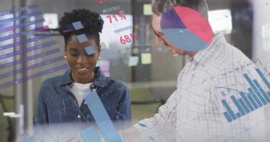 Man and woman coworkers pointing tablet projecting transparent charts, reviewing business data. Analytics, collaboration, innovation, technology, modern, teamwork, corporate