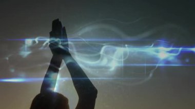 Silhouette woman holding yoga pose on beach, digital streak appearing and weaving around arms. Meditation, serenity, spirituality, kinetic, ethereal, mindfulness, abstract