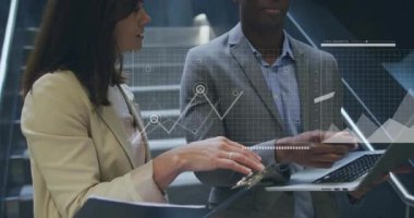 Male and female colleagues holding devices reviewing charts and tapping data initiating tech map. Business, technology, analytics, corporate, data, partnership, innovation