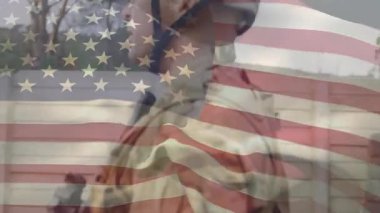 Digital flag overlay pulsing causing camera panning over vigilant military soldiers scanning site. Patriotism, security, vigilance, discipline, tactical, defense, camaraderie