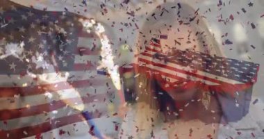 Man lighting sparkler sparks flying, woman waving sparkler celebrating marketing with flag confetti. Celebration, festivity, independence, joy, friendship, fireworks, vibrant