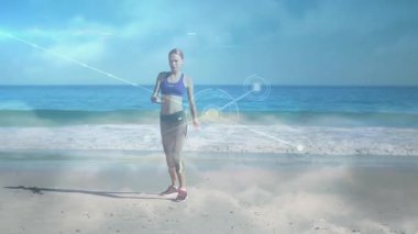 Beden eğitimi hocası sahilde omuz germe hareketi yapıyor, ağ düğümleri ve çizgileri etrafında kayboluyor. Sağlık, canlılık, dinginlik, teknoloji, uyum, motivasyon, açık hava