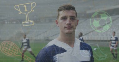 Stadyum sahasında, dijital spor ikonlarıyla donanma üniforması giyen bir futbolcu. Sporcular, takım çalışması, stadyum, aktif, rekabetçi, modern, dinamik