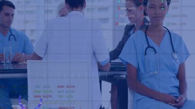 Hemşire, tıbbi ekip masanın etrafında toplanırken kameraya gülümsüyor ve veri işaretlerini ve grafiklerini inceliyor. İşbirliği, sağlık, analitik, takım çalışması, profesyonellik, yenilik, veri görselleştirme