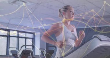 Koşu bandına adım atan kadın koşucu spor salonunda gövdede dijital titreşim oluşturmaya başlıyor. Fitness, teknoloji, hareket, sağlık, spor, modern, dijital