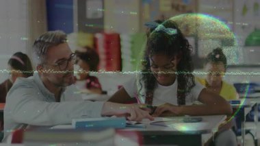 Teacher tapping workbook page and guiding student hand placement as student writing for learning. Education, mentorship, childhood, literacy, classroom, focus, encouragement