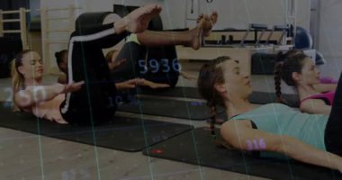 Instructor cueing women doing tabletop pulses on Pilates mats for fitness with floating stats. Fitness, wellness, strength, exercise, group, training, active