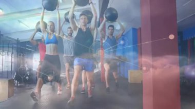 Upon gym class start group of five holding medicine balls doing walking lunges, overlay animating. Exercise, teamwork, strength, dynamic, modern, motivation, training