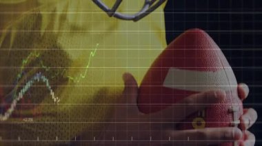 Football player clasping football, lifting helmet and initiating sports graphs with pulsing metrics. Athlete, performance, analytics, fitness, training, digital, innovation