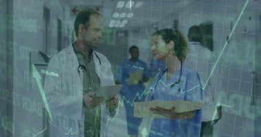 Medical team meeting at station checking status charts on tablet with pulsing line graph animation. Collaboration, healthcare, technology, analysis, diagnostics, professionalism, communication