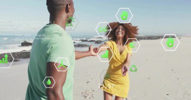 Sürdürülebilirliği destekleyen yüzen eko ikonlarıyla kumlu sahilde dans eden bir çift. Romantizm, kutlama, uyum, canlılık, çevre bilinci, neşe, hareket