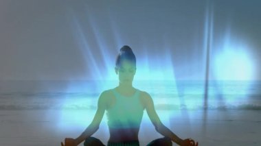 Bir kadın, el ele tutuşarak sahil yastığında, gövdenin arkasındaki aura gibi derinleşen meditasyondan medet umuyor. Farkındalık, sükunet, maneviyat, dinginlik, enerji, denge, doğa