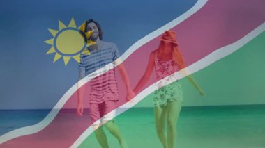 Namibya seyahatinin reklamını yapmak için el ele tutuşan bayrağın üzerinde. Romantizm, macera, özgürlük, eğlence, seyahat, sükunet, bağlantı