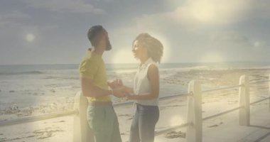 Korkuluklara ulaşan çift el ele tutuşuyor ve bokeh örtüleriyle okyanusta yaşam tarzlarını paylaşıyorlar. Romantizm, samimiyet, bağlantı, rahatlık, sükunet, doğal, samimi