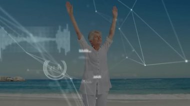 Üst düzey kadın kollarını kaldırarak sağlık verilerini eşleştirme hareketini başlatıyor, kumsala uzanıyor. Sağlık, farkındalık, dinginlik, fitness, dijital sanat, eğlence, canlılık