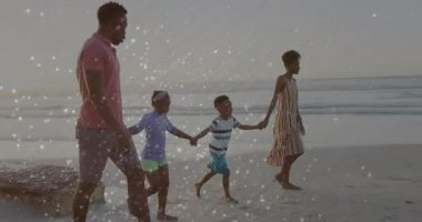 Sahilde çıplak ayakla yürüyen aileyi gösteren kamera görüntüleri, seyahatin altını çiziyor. Deniz kenarı, rahatlama, beraberlik, dinginlik, rahatlık, açık hava, tatil
