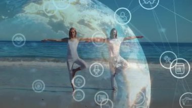 Yoga ikilisi plajda kol uzatarak dijital küreye sağlık için girdap oluşturan ağ simgeleri oluşturuyor. Fitness, farkındalık, teknoloji, sağlık, bağlantı, dinginlik, doğa