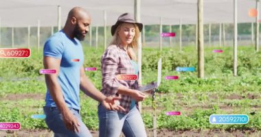 Uzman adam elinde dizüstü bilgisayarı olan bir kadınla sulama hattını geçiyor. Ekin verilerini örtüyor. Tarım, teknoloji, veri, kesinlik, ekosistem, sürdürülebilir, el bilgisayarı