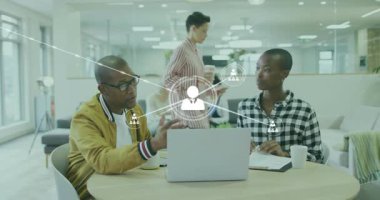 İş arkadaşları, ağ simgeleri bağlantıları genişletirken dizüstü bilgisayarı işaret ediyorlar. İşbirliği, takım çalışması, bağlantı, ağ oluşturma, yenilik, iletişim, modernite