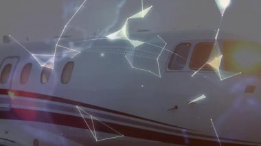 Jet gövdesi üzerinde sürüklenen ağ hatları birleşerek dönen dünyaya bağlanıyor ve bağlantıyı gösteriyor. Futuristik, teknoloji, bağlantı, havacılık, dijital, ağ, küresel