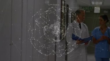 Holografik küre medikal salonda beliriyor. Sürücü doktor ve hemşire silinene kadar klasörleri inceliyor. Gelecekçi, klinik, teknoloji, işbirliği, yenilik, sağlık, görselleştirme