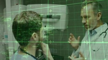 Kıdemli doktor yeşil hizalama ızgarası gösteren kıdemsiz sıhhiyeyi eğitmek için tarayıcı kullanımını açıklıyor. Tıbbi, eğitim, teknoloji, işbirliği, yenilik, klinik