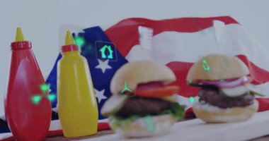 Odaklanma değişimi, sürdürülebilirliği göstermek için bayraklı ve eko ikonlu iki mini burgerin sürüklendiğini gösteriyor. Fast food, vatanseverlik, dijital arayüzler, çevreci farkındalık, gündelik yemek, yenilenebilir enerji, çevrecilik