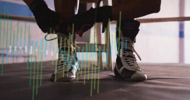 Dantelli boksör boks ringinin içinde diz çöküp ayakkabı bağcıklarını bağlıyor. Atletik, kararlılık, eğitim, odaklanma, spor, disiplin, fitness