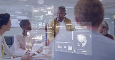 Orta seviye yönetici, iş analizi yaparken holografik çizelgelerde masa jestlerine yaslanıyor. Şirket, takım çalışması, yenilik, veri görselleştirme, profesyonel, işbirliği, modern