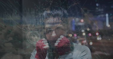 Holding fists boxer wearing hoodie and red wraps in night city skyline, with digital overlay. Athlete, cybersecurity, futuristic, urban, strength, digital, empowerment