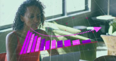 Analyzing woman wearing orange top reviewing laptop data at coworking lounge, purple chart overlay. Technology, productivity, collaboration, innovation, contemporary, workspace, growth