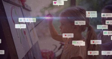 Two school-age girls painting colorful strokes at easels in home art corner, with reaction icons. Creative, education, trend, vibrant, collaboration, inspiration, playful