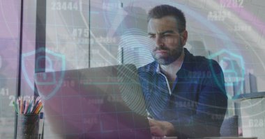 IT professional in dark blue shirt typing on laptop analyzing data in office, with colored pencils. Technology, workspace, urban, analysis, concentration, modern, productivity