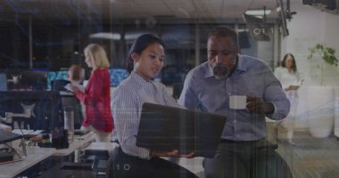 Collaborating woman in striped blouse holding laptop and man holding coffee mug in modern office. Collaboration, teamwork, modernity, workstation, corporate, productivity, professional