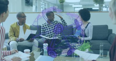 Gesturing woman wearing plaid shirt leading discussion in office lounge, with coffee cups, tablet. Collaboration, teamwork, modern, informal, communication, brainstorming, workspace