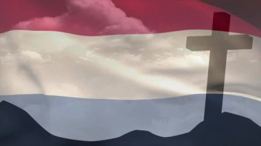 Breeze sending rippling flag folding over clouds to simulate wind, cross silhouette standing fixed. Patriotism, spirituality, serenity, illustration, inspiration, symbolism, faith