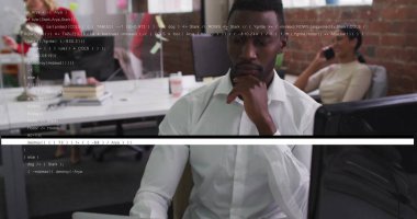 Focusing man wearing white shirt coding at open plan office, with coffee mug and smartphone. Corporate, teamwork, productivity, modern, professional, collaboration, technology
