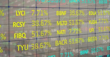 Displaying glass panel overlaying grid on trading floor, showing ticker codes and percentage data. Financial, technology, data, analytics, digital, modern, investment