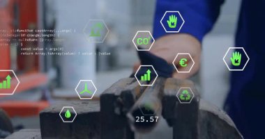 Tezgahtaki çelik boruyu silen teknisyen yeşil altıgen simgelerini güncelleyerek karbondioksit ölçümlerini gösteriyor. Sanayi, işçilik, bakım, analitik, sürdürülebilirlik, mühendislik, kesinlik.