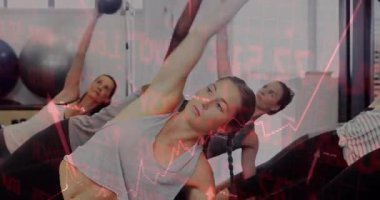 Women initiating side plank on mats engaging obliques by lifting medicine balls in fitness class. Fitness, group workout, mobility, strength training, athletic, wellness, dynamic