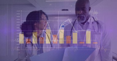 Reviewing charts medical team in lab coats at hospital corridor, with laptop, digital chart overlay. Healthcare, medical, technology, data, analysis, professionalism, clinical